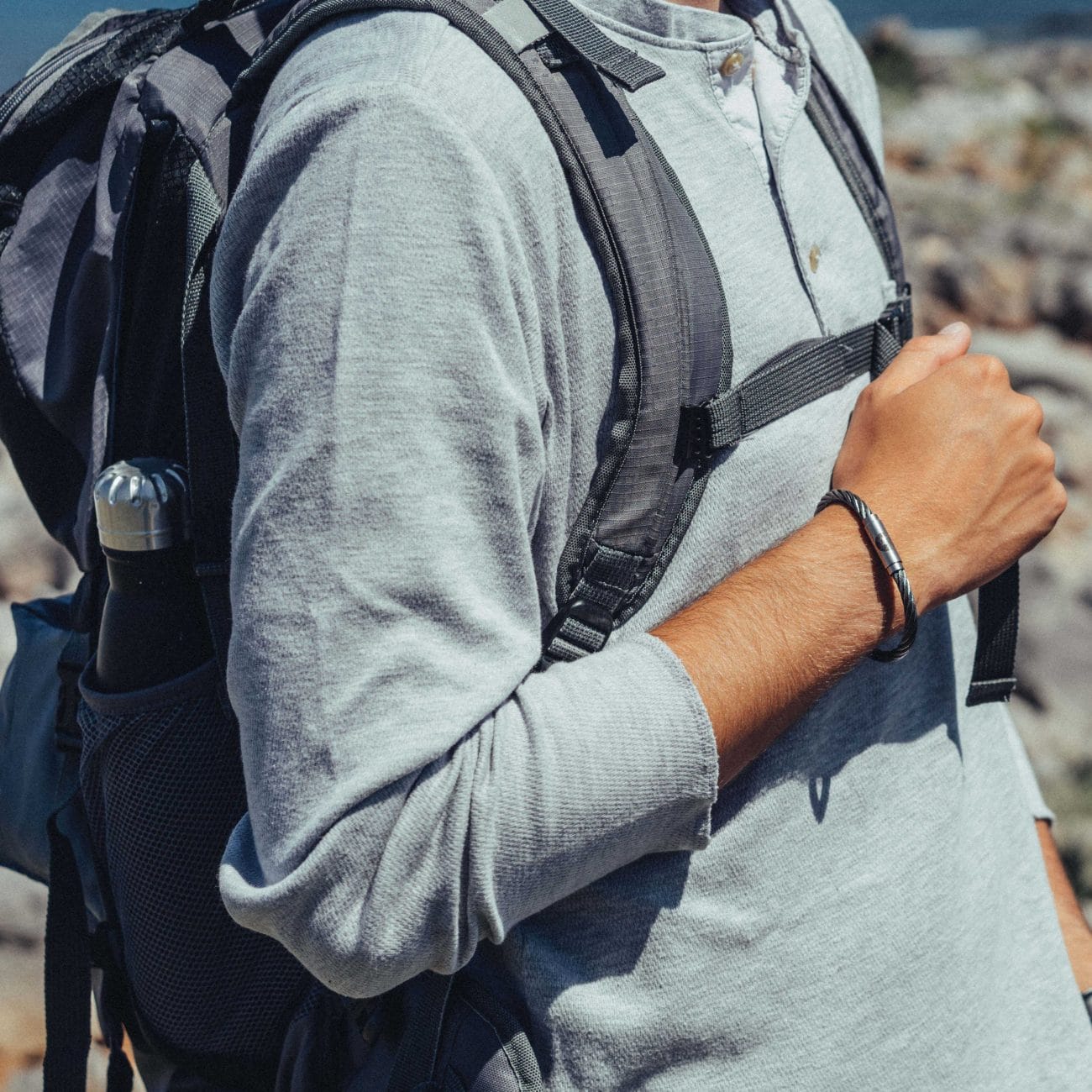 Man outdoors wearing steel rigging bracelet